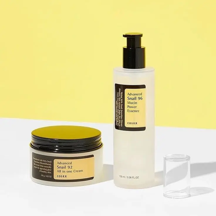 cosrx hydrating skin duo for dry skin with snail mucin essence and all in- one cream on a minimal background.